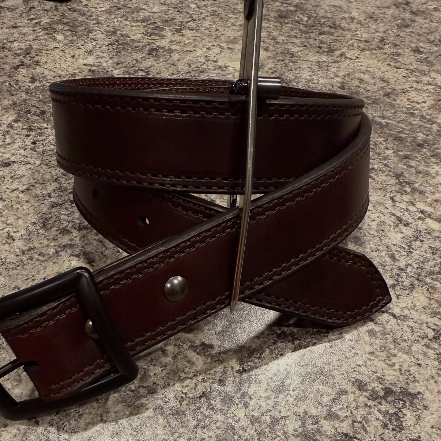 Sewing machine stitching moccasin brown leather — behind the scenes