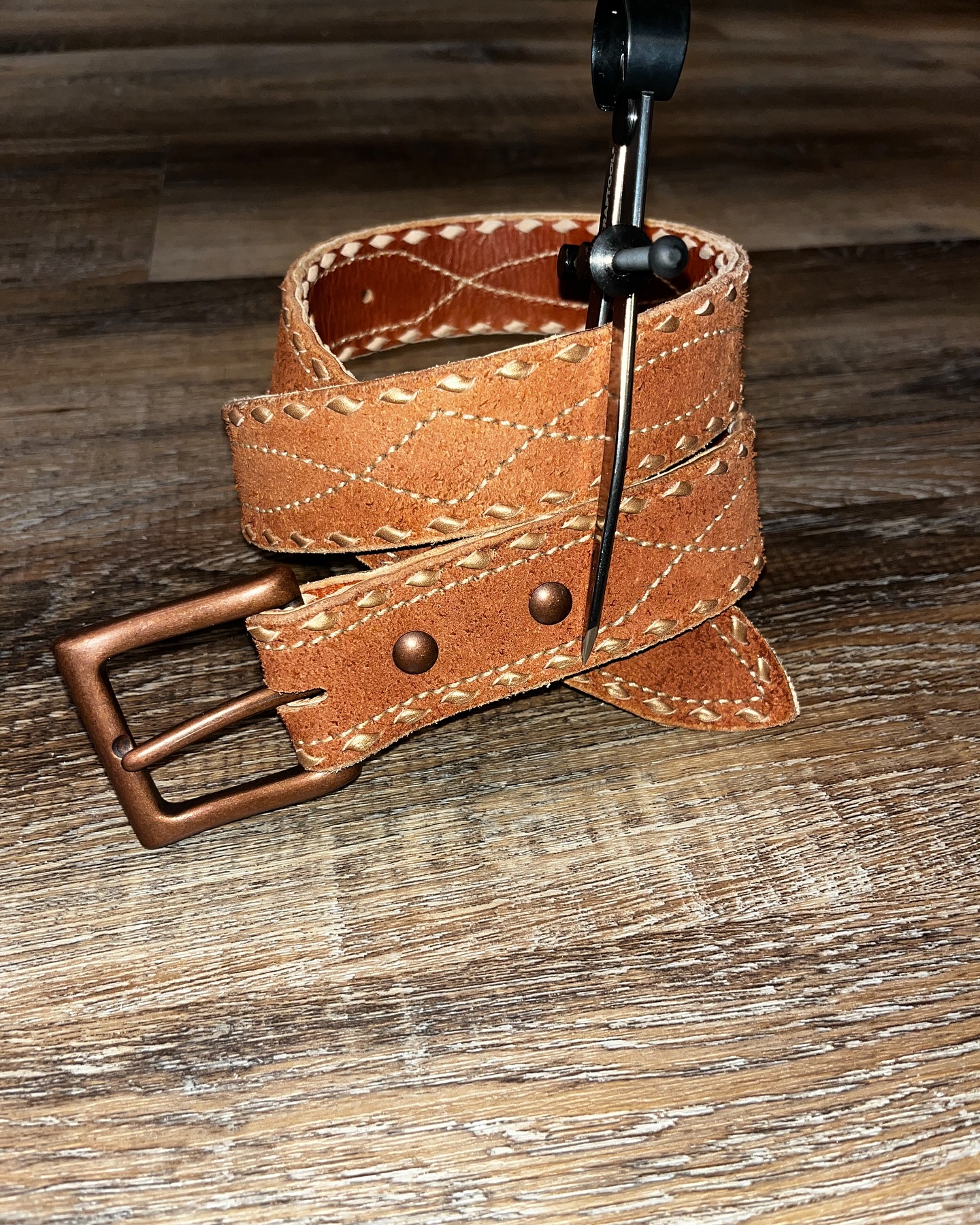 Tan leather belt with classic buck stitch and copper buckle