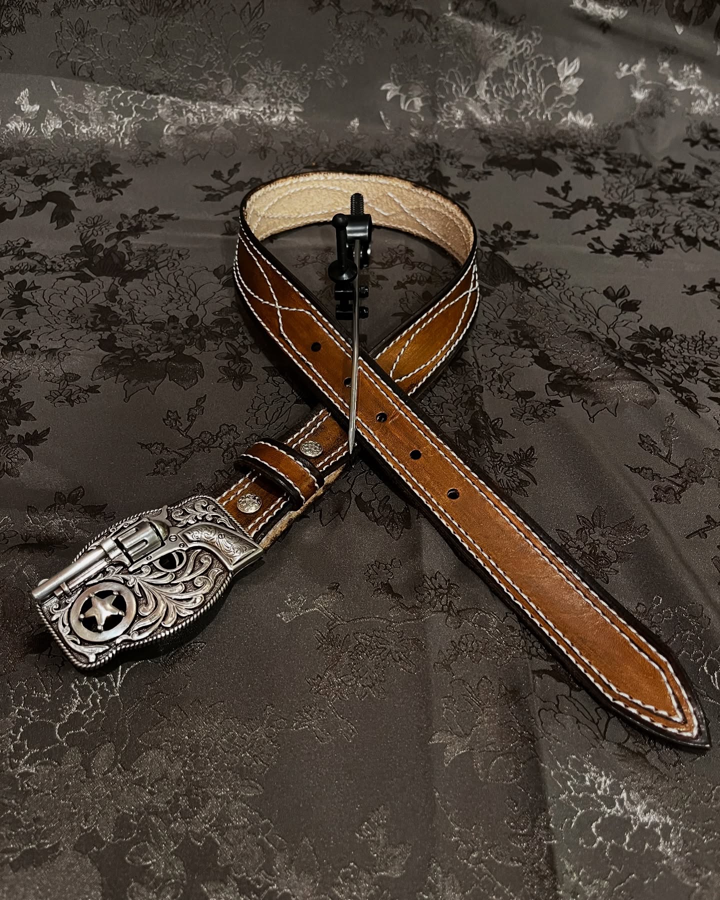 Tan leather belt with western star buckle